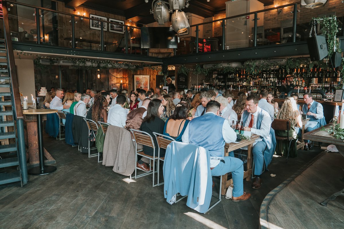  Wedding guests enjoying the wedding breakfast inside Balfour St Barts in Smithfield, London 