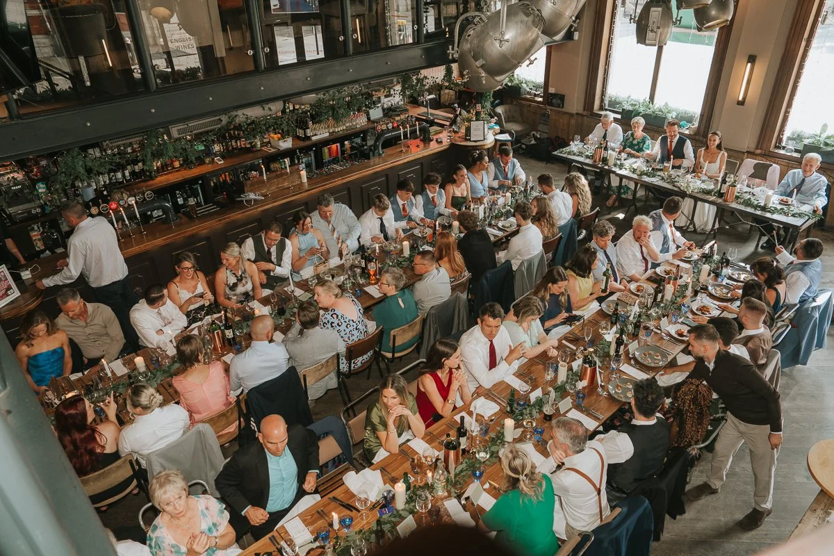  View from the mezzanine overlooking guests dining during a wedding reception at Balfour St Barts in Smithfield. 