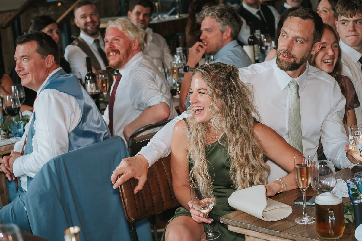  Wedding guests laughing and enjoying the speeches during a Balfour St Barts wedding reception. 