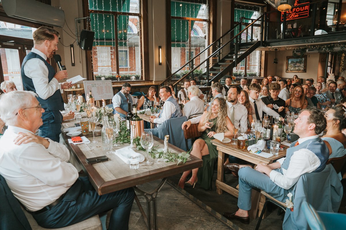  Groom entertaining guests with his speech during a lively wedding reception at Balfour St Barts. 