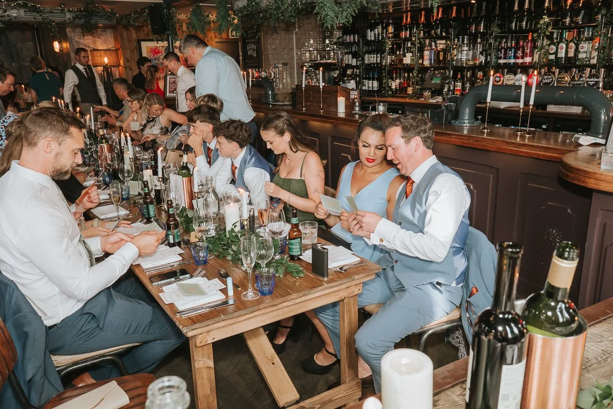  Wedding guests seated around long tables during the reception at Balfour St Barts in Smithfield. 