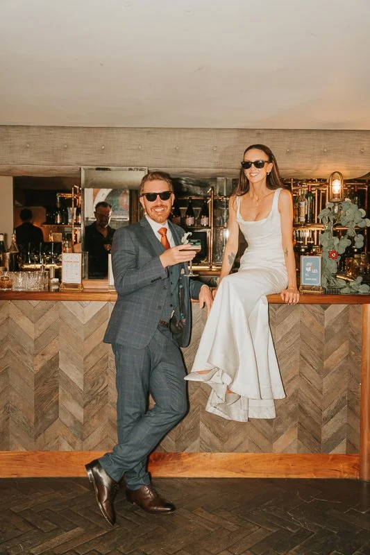  Bride and groom posing at the bar during their relaxed Balfour St Barts wedding reception in Smithfield. 