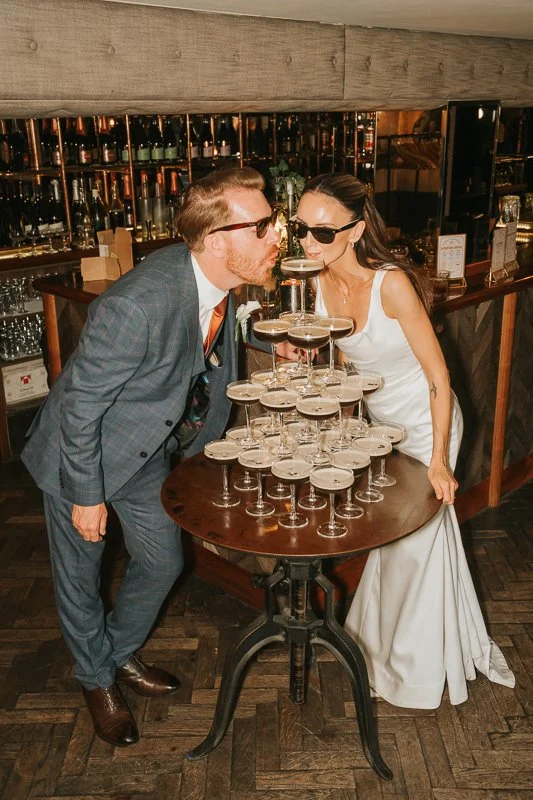  Bride and groom enjoying a martini tower at their Balfour St Barts wedding reception in Smithfield, London. 