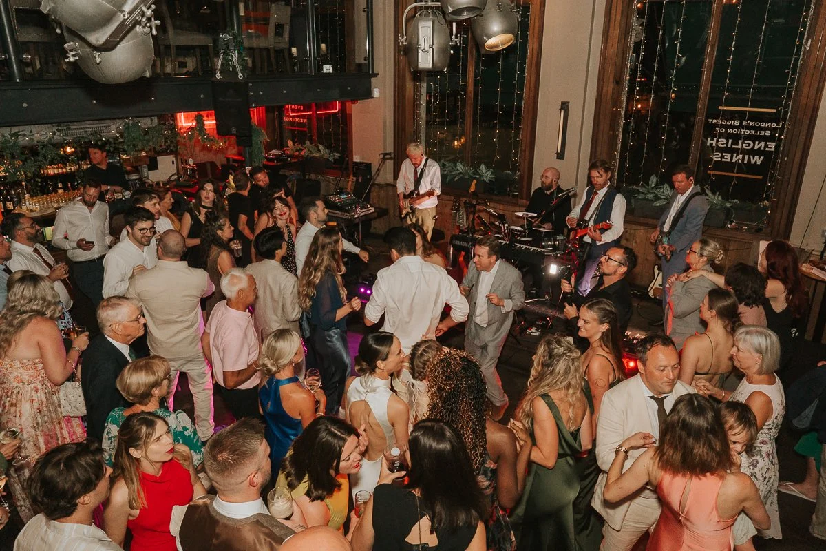  View from the mezzanine of a packed dance floor and live band at a Balfour St Barts wedding in London. 
