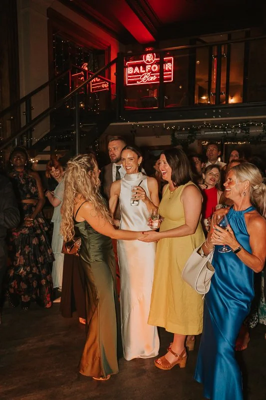  Bride dancing with wedding guests during the evening reception at Balfour St Barts in Smithfield, London. 