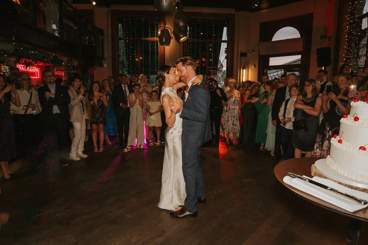  Bride and groom sharing their first dance surrounded by guests at Balfour St Barts wedding venue. 