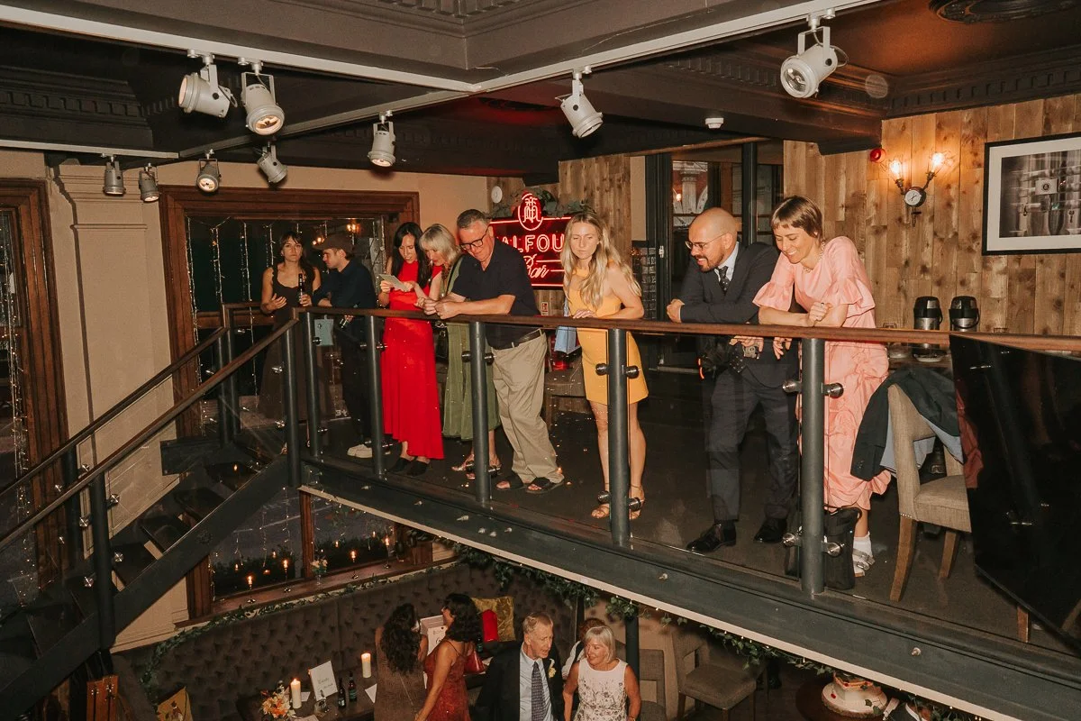  Wedding guests watching the celebrations from the mezzanine inside Balfour St Barts. 
