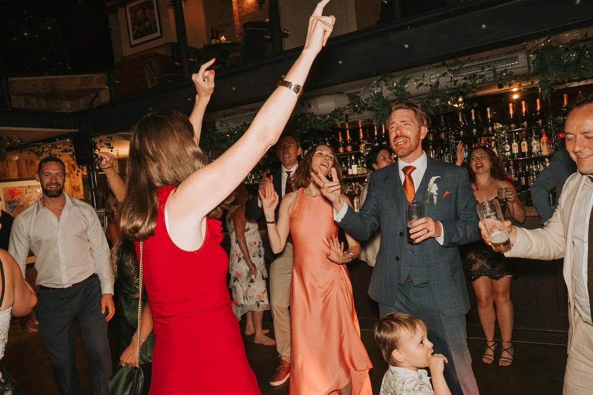  Groom dancing with friends during the evening celebrations at Balfour St Barts in London. 