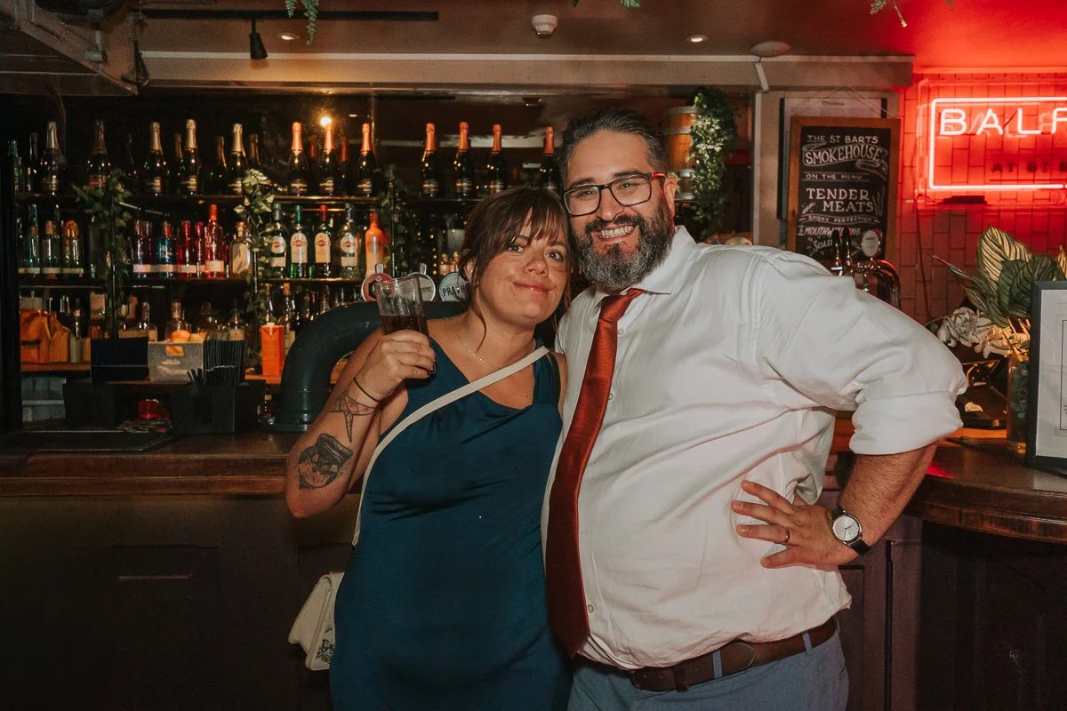  Wedding guests enjoying drinks at the bar during a relaxed Balfour St Barts wedding reception. 