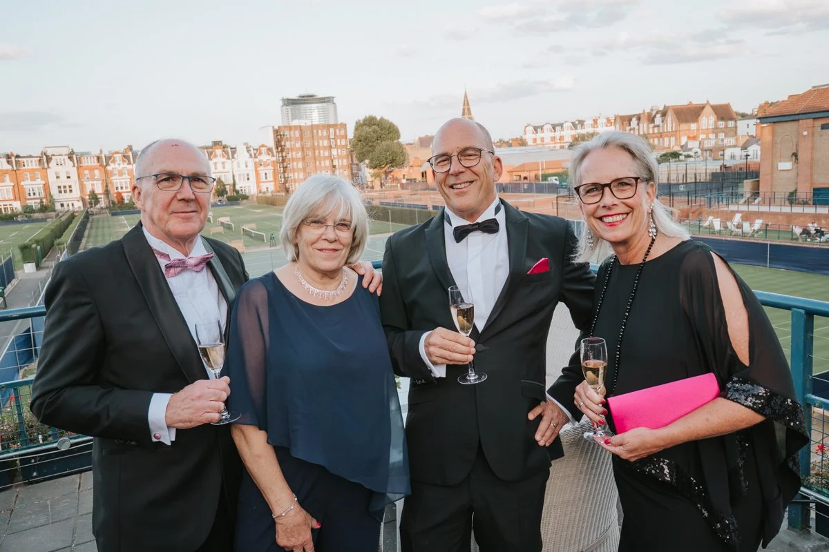  Guests enjoying champagne on the terrace at The Queen’s Club during a 30th birthday party in London. 