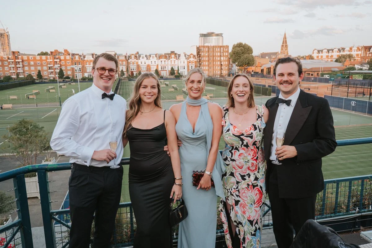  Guests enjoying champagne on the terrace at The Queen’s Club during a 30th birthday party in London. 