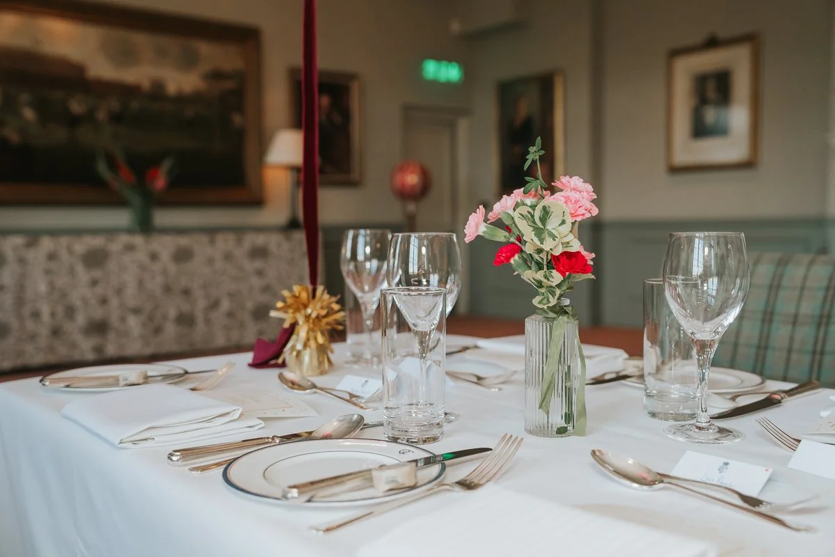  Pink floral table arrangement and place settings for a private birthday dinner at The Queen’s Club. 