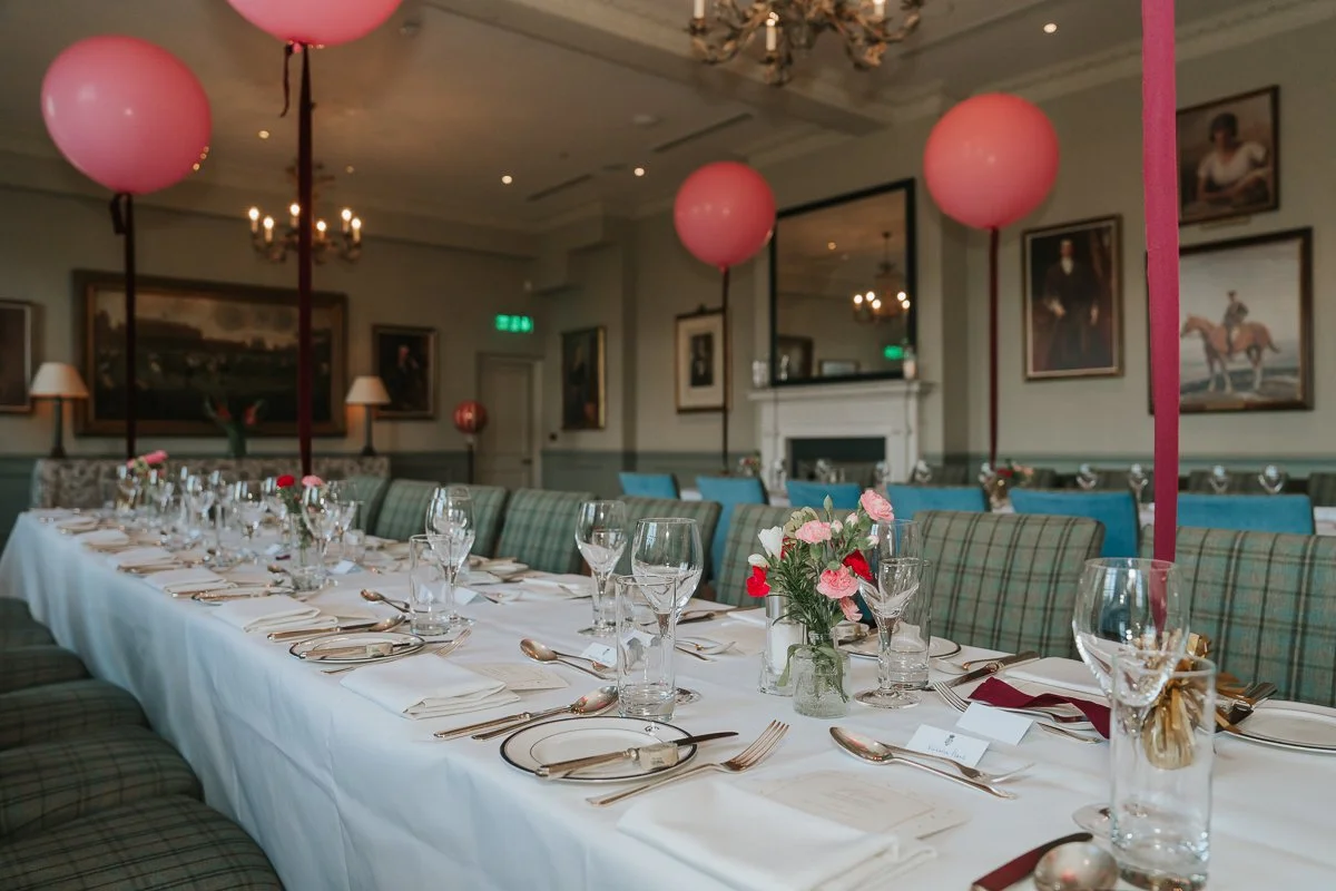  Long table prepared for a sit-down 30th birthday meal in The Queen’s Club private dining room. 