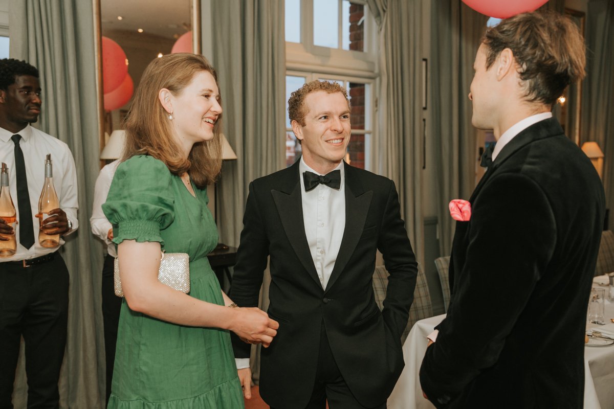  Guests chatting before dinner at a private birthday celebration at The Queen’s Club. 