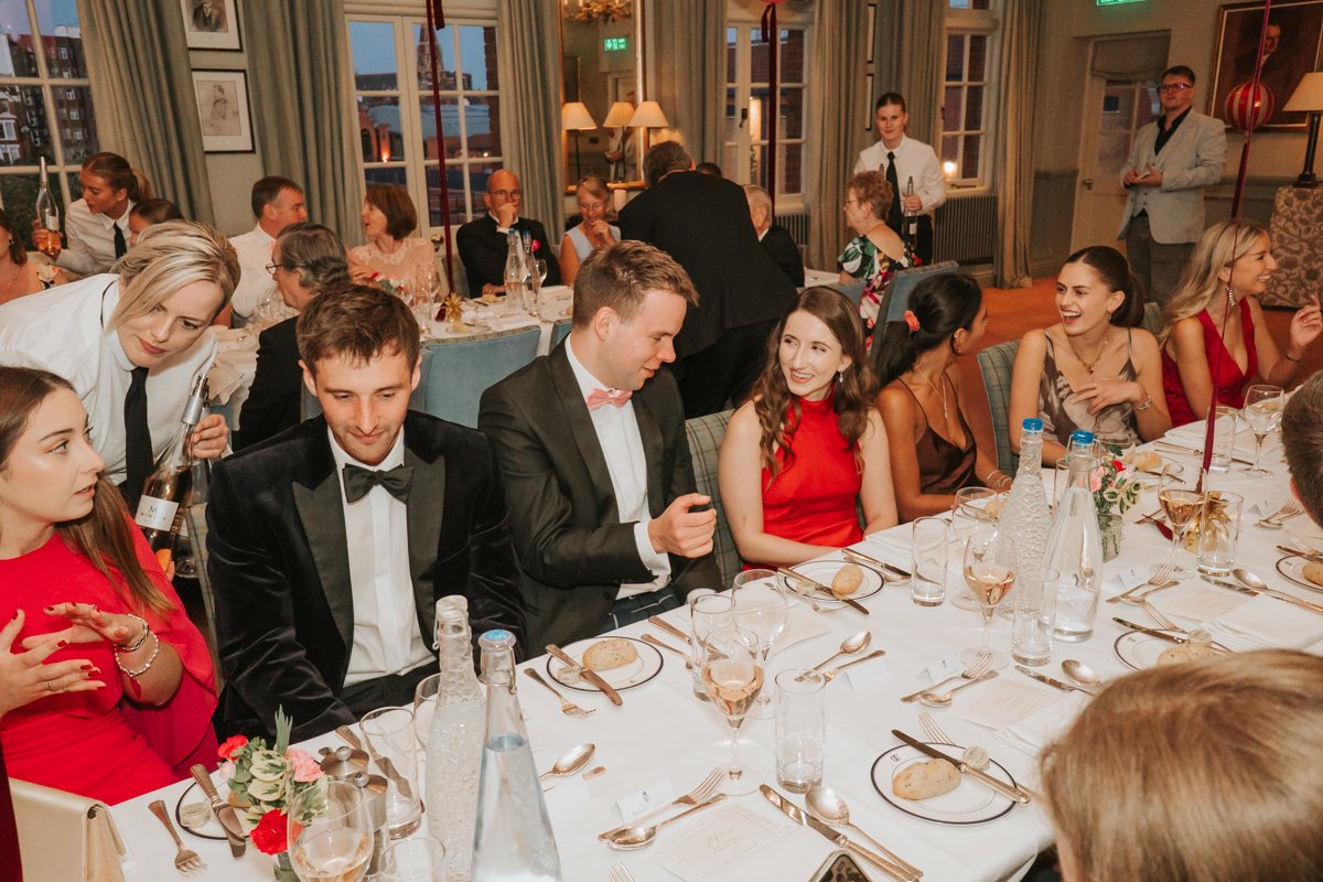  Friends and family enjoying a lively sit-down birthday dinner in The Queen’s Club private dining room. 