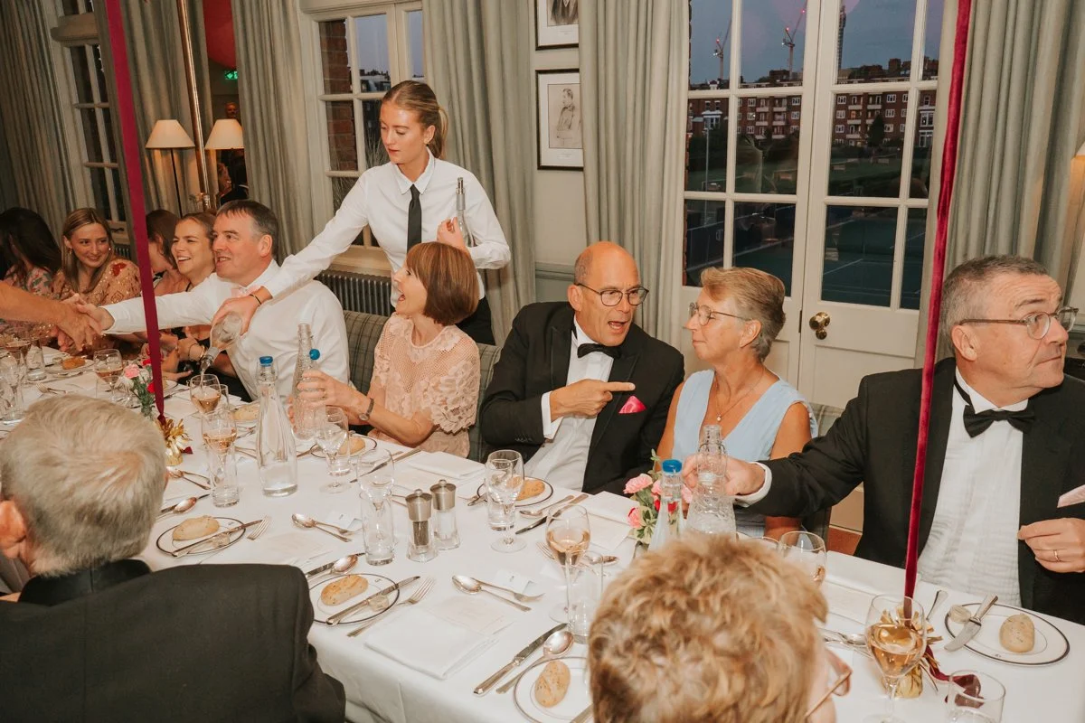  Friends and family enjoying a lively sit-down birthday dinner in The Queen’s Club private dining room. 