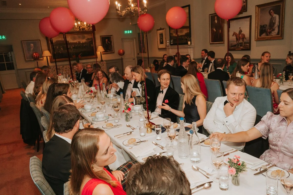  Friends and family enjoying a lively sit-down birthday dinner in The Queen’s Club private dining room. 