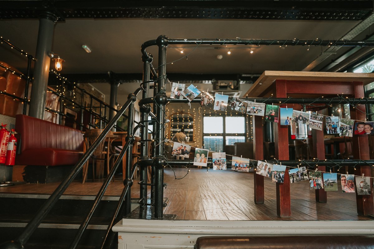  Wedding photographs displayed around the industrial-style interior of The Depot during an Islington wedding reception. 