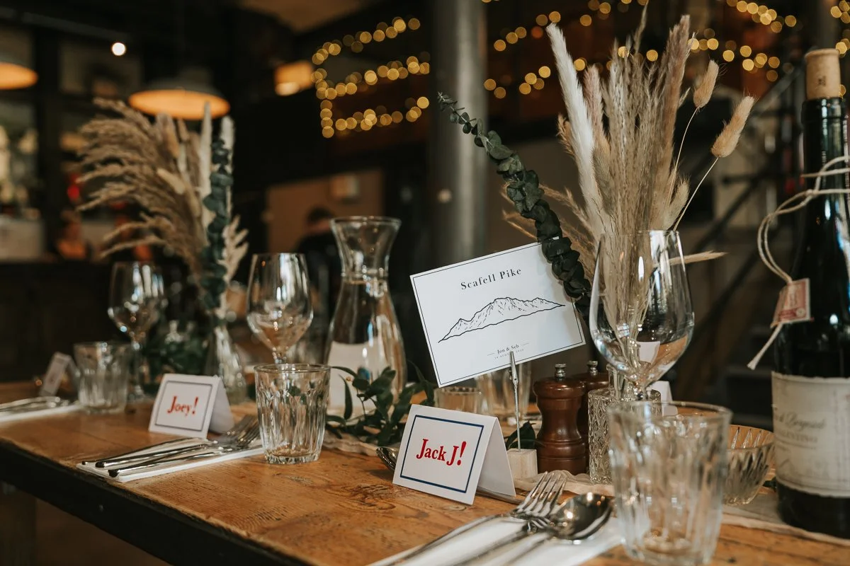  Wedding table setting at The Depot Islington with dried flowers, wine glasses and personalised place cards. 
