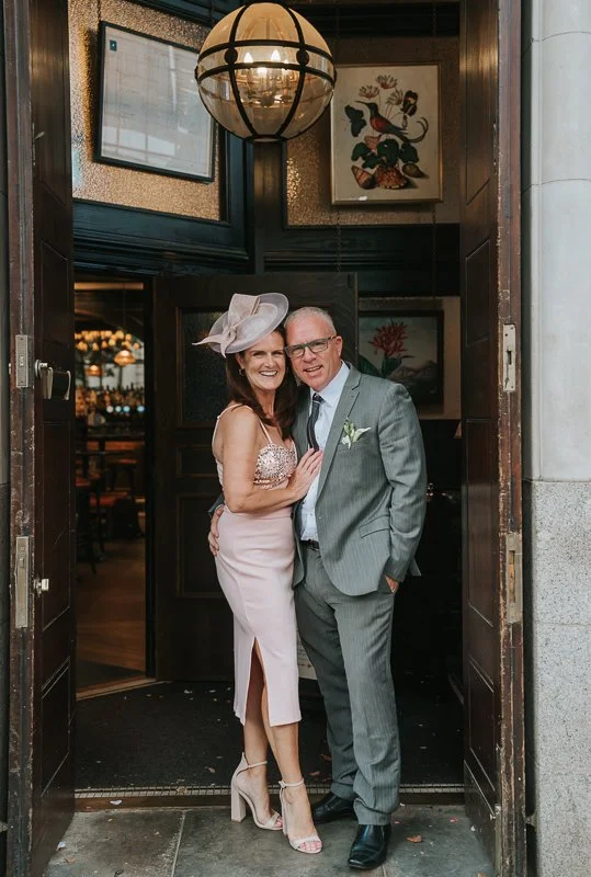  Two wedding guests posing in the doorway of The Trafalgar pub in Chelsea. 