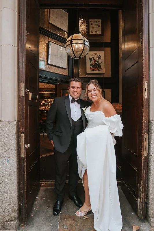  Bride and groom together at the entrance to their Chelsea pub wedding reception. 