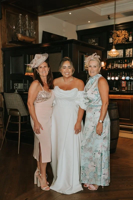  Bride posing with two guests during her relaxed pub wedding reception on the King’s Road. 