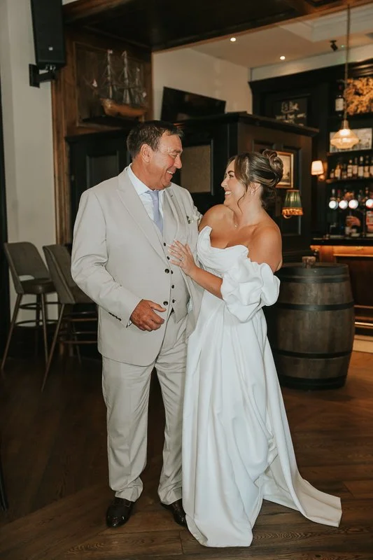  Bride laughing with a guest during her celebration at The Trafalgar after a Chelsea Town Hall wedding. 