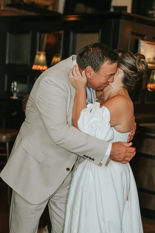  Bride embracing a wedding guest during an emotional moment at The Trafalgar reception. 
