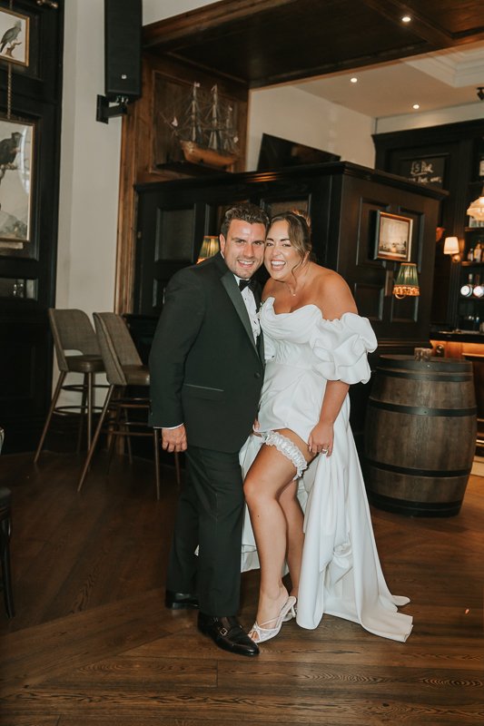  Bride and groom laughing together during their relaxed wedding celebration at The Trafalgar Chelsea. 