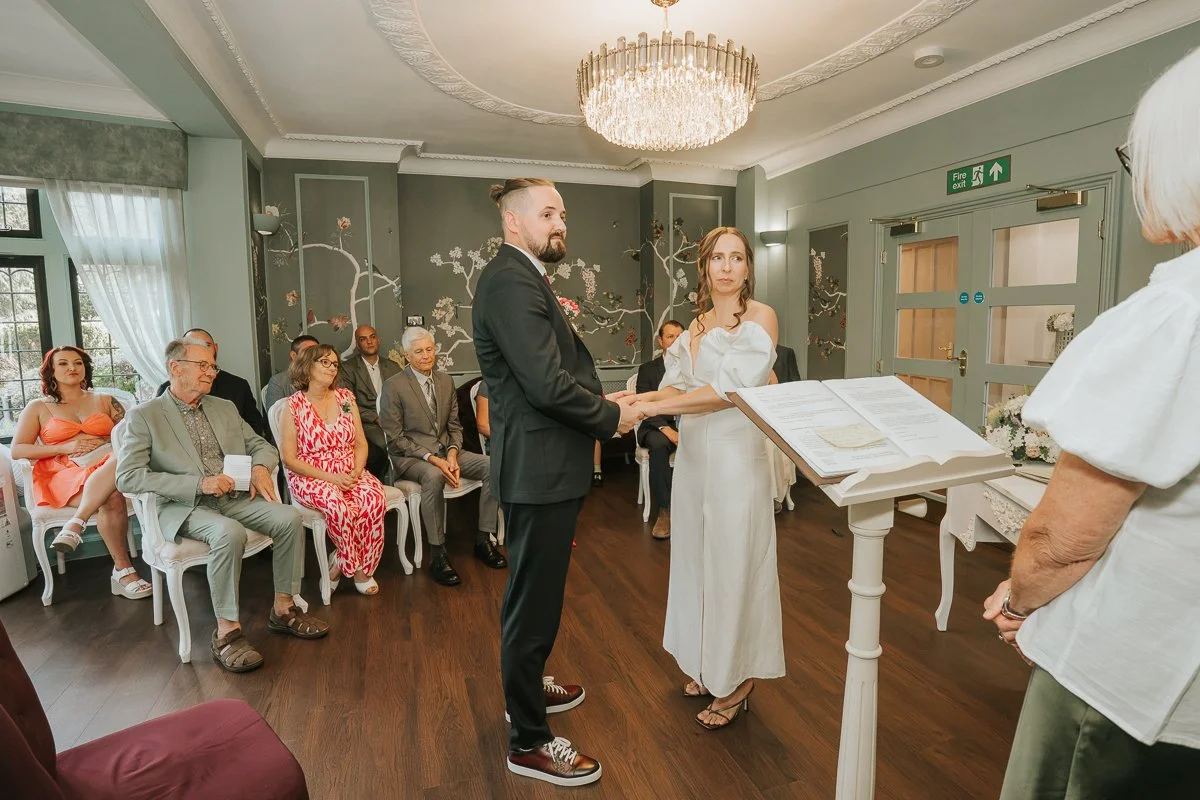  Weybridge Register Office wedding photography of the couple exchanging vows in front of family and friends. 