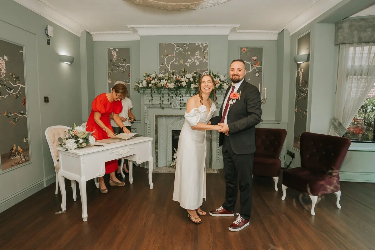  Newly married couple smiling together after their ceremony at Weybridge Register Office in Surrey. 