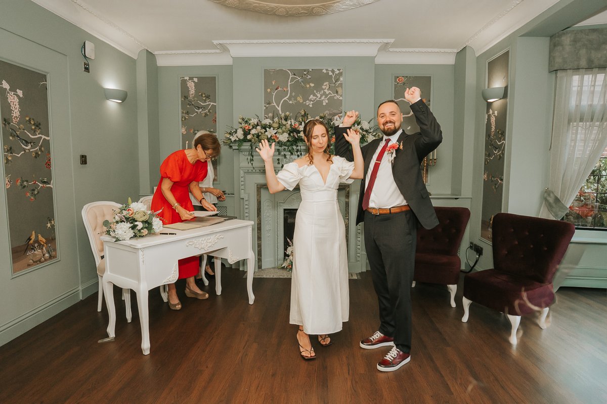   Bride and groom celebrating after getting married at Weybridge Register Office.  