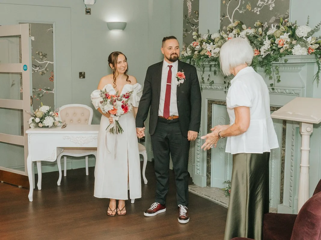  Weybridge Register Office wedding photography of the newlyweds standing together at the end of their civil ceremony. 
