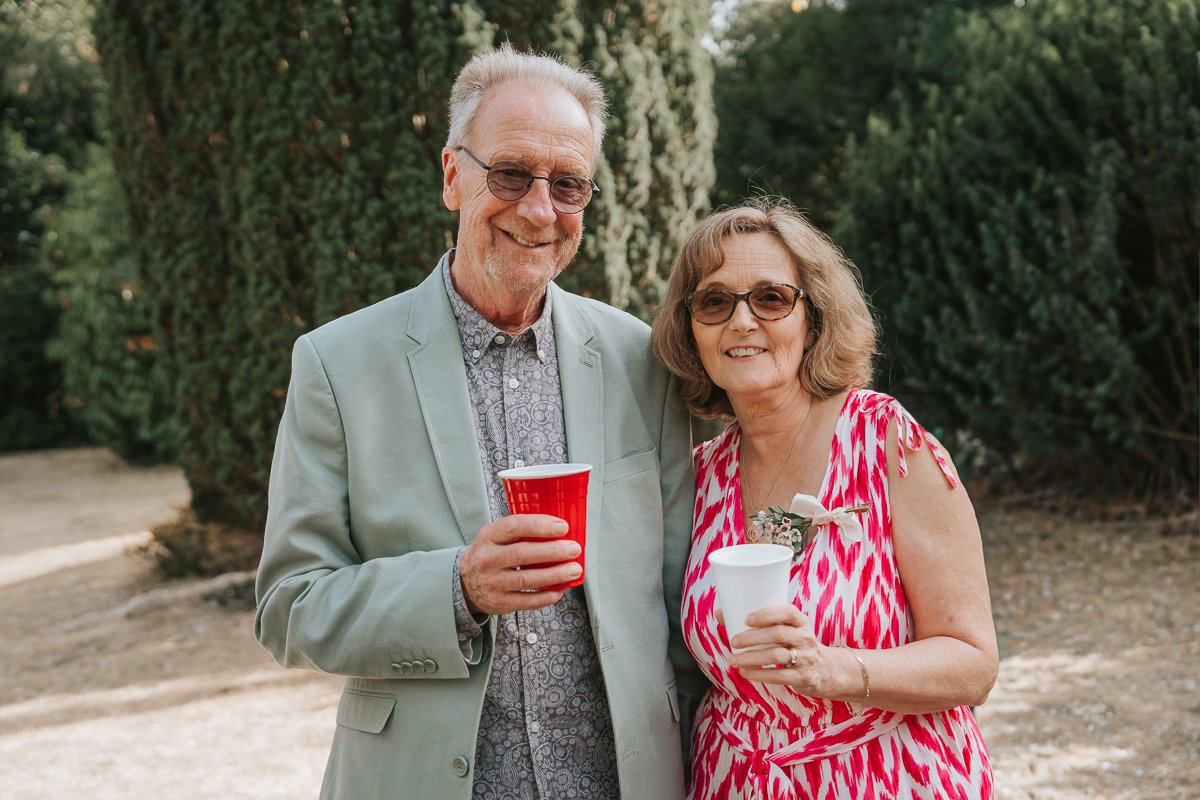  Wedding guests enjoying drinks in the gardens at Weybridge Register Office after the ceremony. 