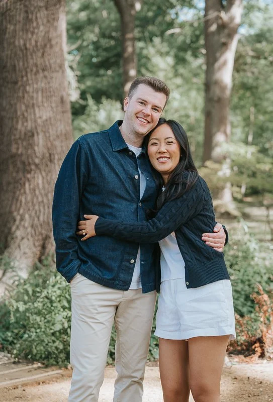  Couple hugging beside a large tree during their Isabella Plantation engagement photoshoot. 