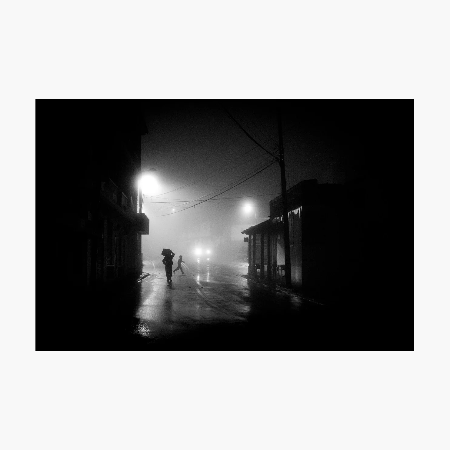 @harrywedmonds Chugchilán, Ecuador, South America January 2018 The last in my selection was captured after a very long day hiking the Quilotoa Loop. In the pouring rain. All I really wanted was a hot shower, a plate of food, and some much needed sleep. But the fog shrouding the town of Chugchilán was too enticing. Although ominous in tone, the child in full sprint with both feet off the ground brings a wonderful touch of joy to this photograph. There's also a third figure to be found in the scene, lurking in the shadows. Photographed using the FujiFilm X-T2 and the XF35 F2 WR .