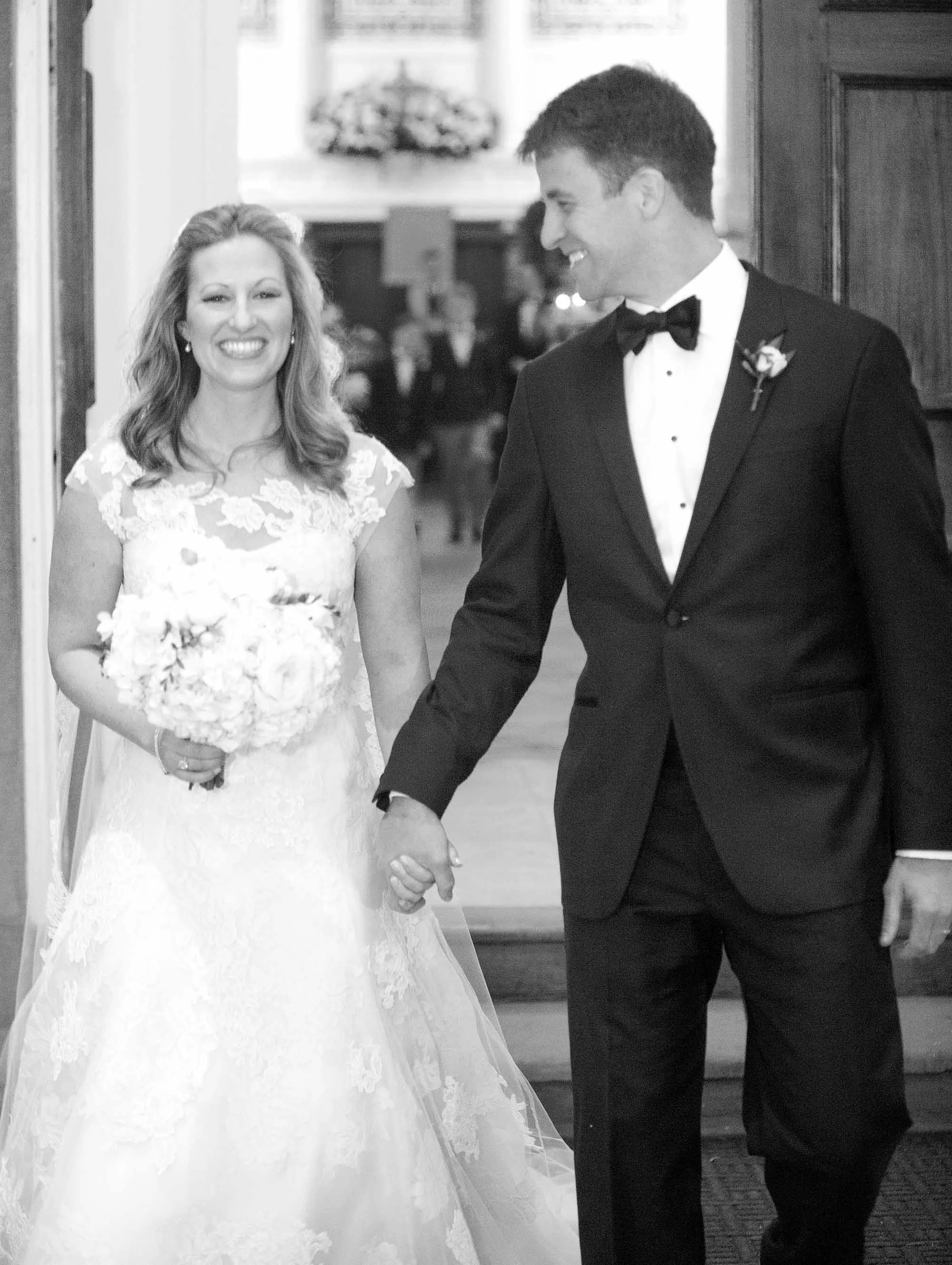 A bride and groom exit First Scots Church in Charleston, SC.
