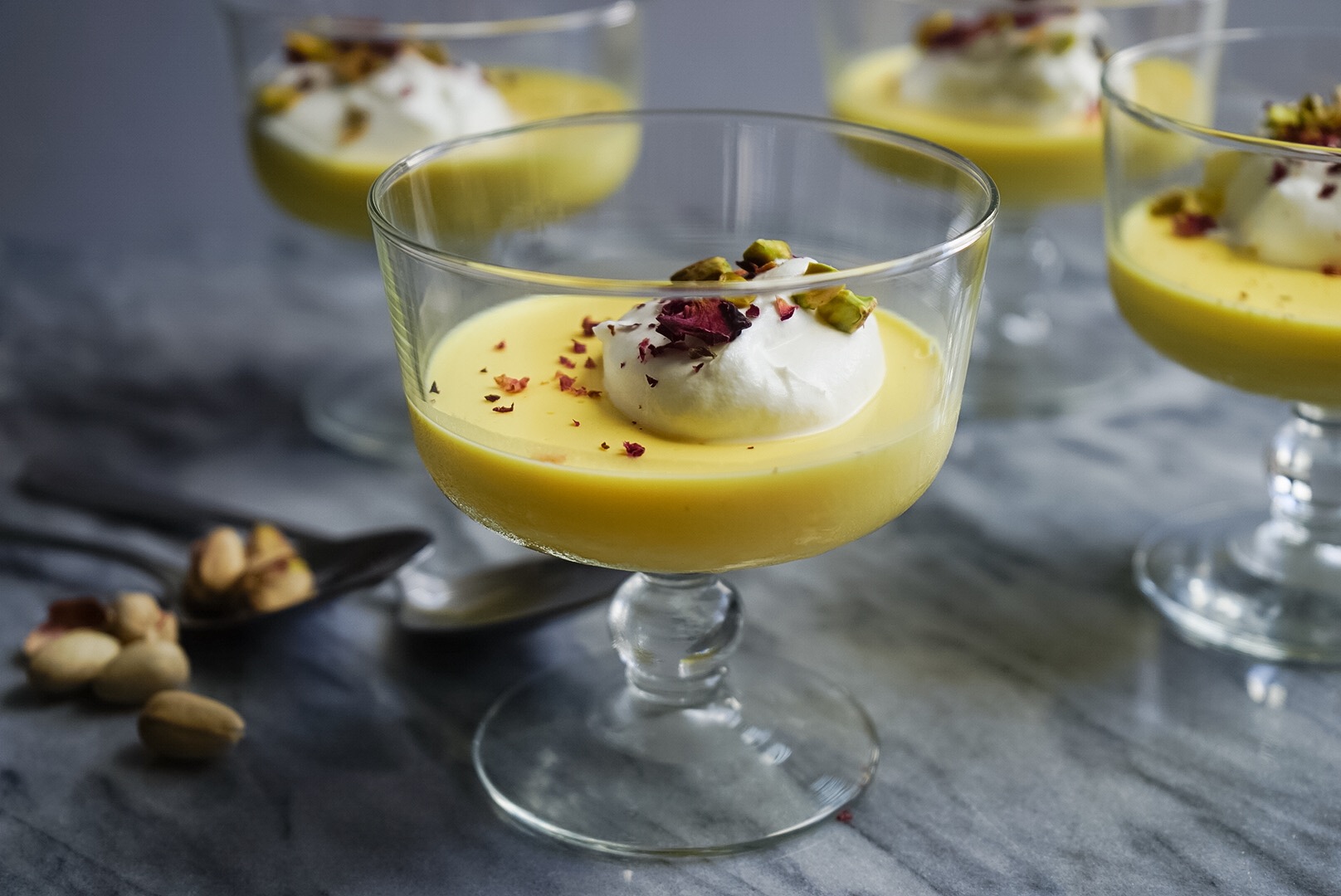 Enjoy these parfait-style saffron panna cottas with a dollop of whipped cream and crushed pistachios.