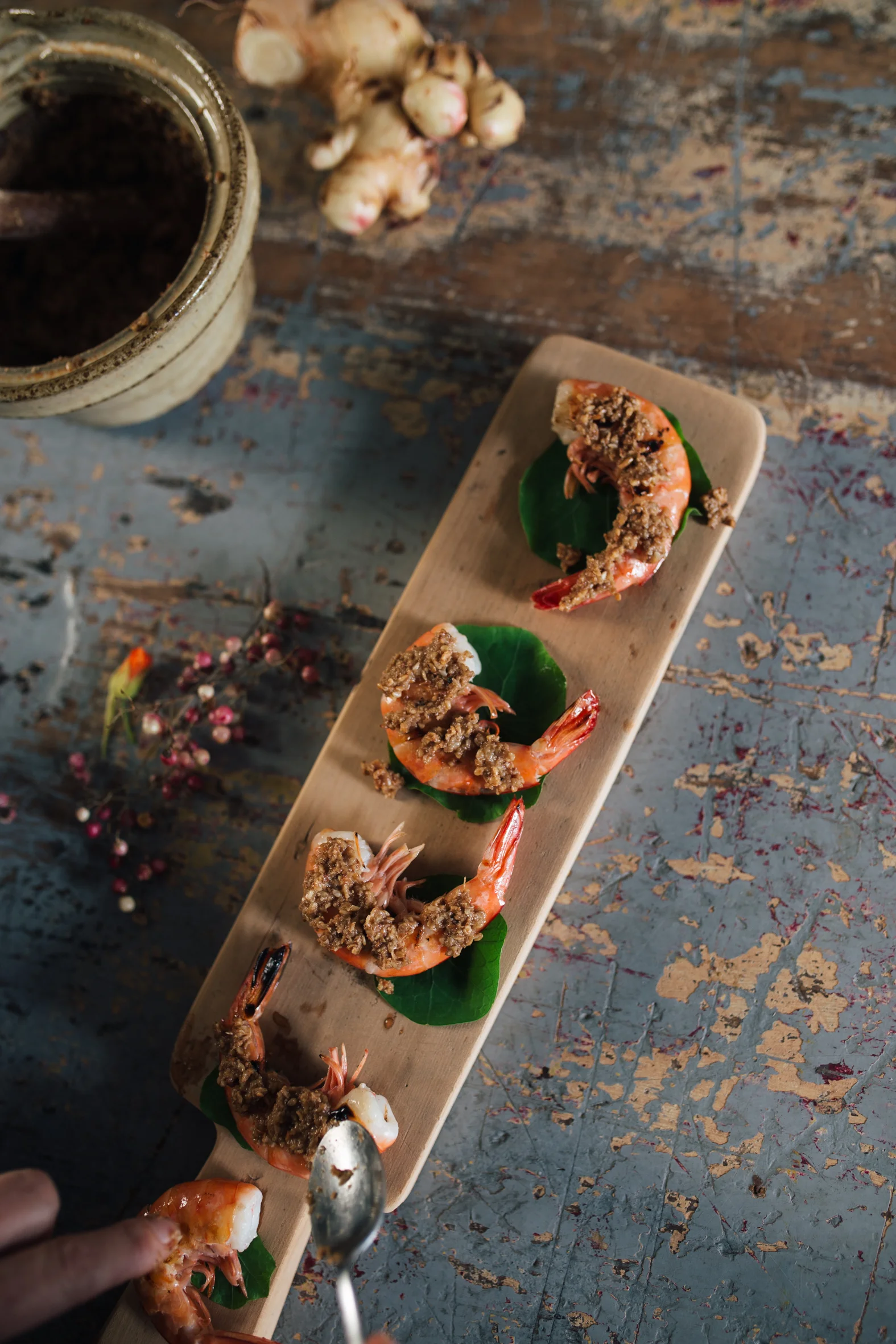 Serve the miso paste on top of char grilled prawns, wrapped in nasturtium leaves
