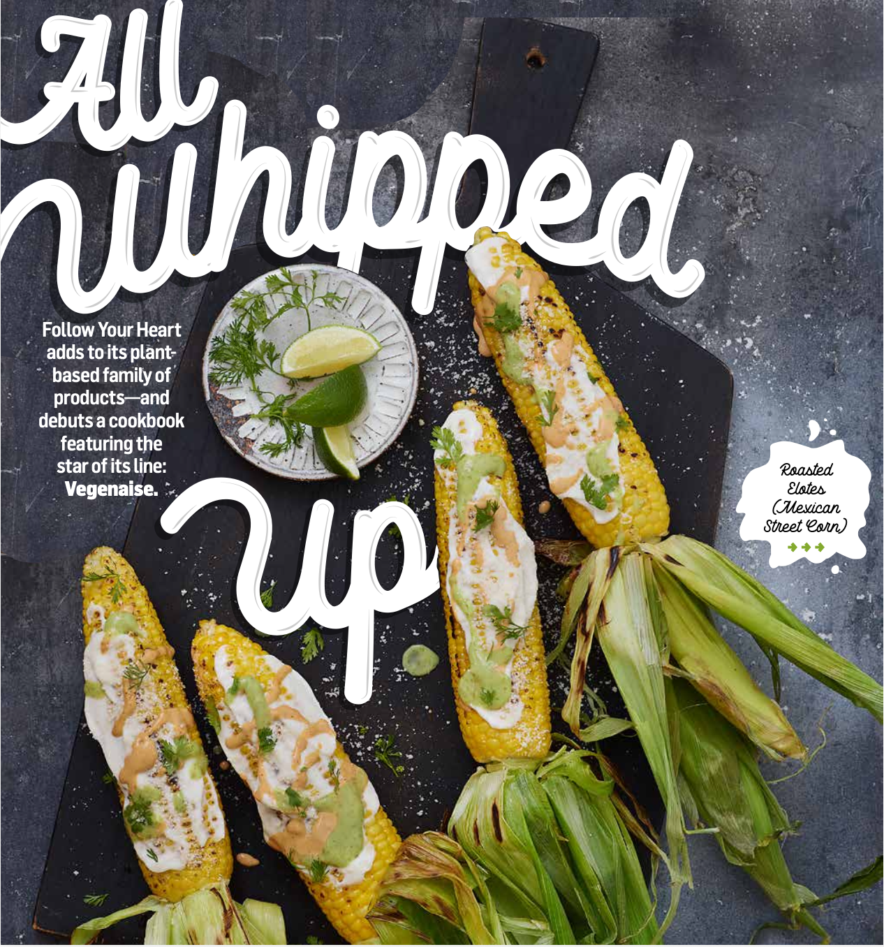 Cooked roasted elote Mexican street corn garnished with herbs and sauces served on the cob, with a side of lime wedges and cilantro on a small plate.