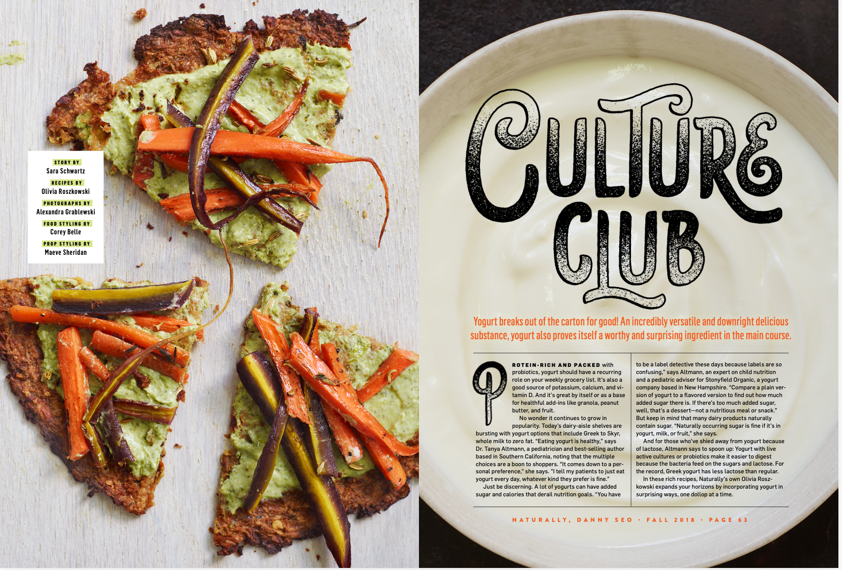 Close-up of a slice of vegetable pizza topped with roasted carrots, purple eggplant, and herbs on a light wooden surface, with a magazine article on yogurt and culture club on the right side.