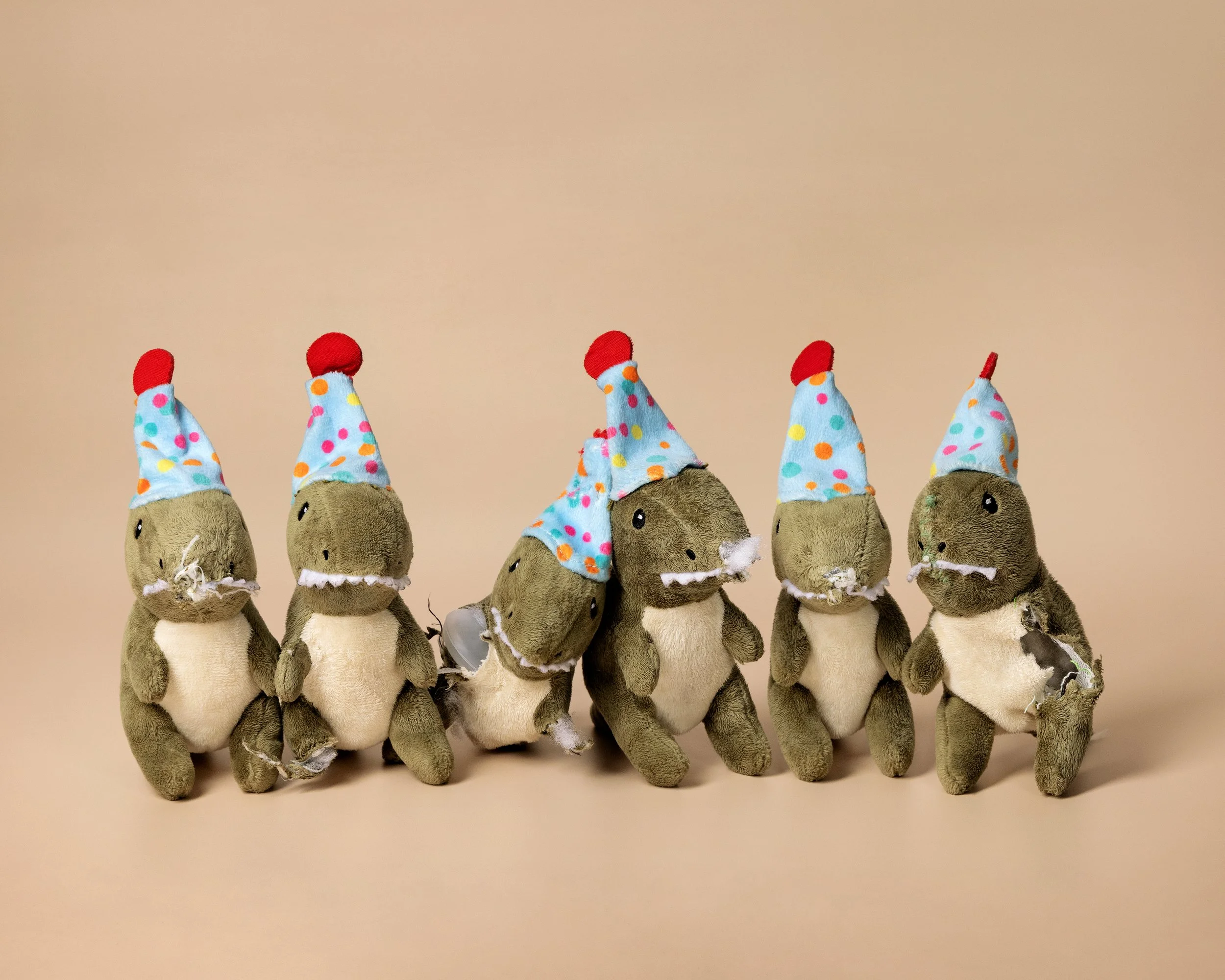  Sherlock &amp; the Dinos: A Series of Mild Destruciton  A set of lightly destroyed dinosaur plushies, compliments of my dog, Sherlock. 