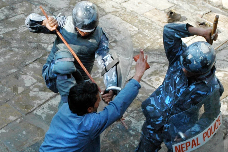 Police corner a pro-democracy protestor, Kathmadu, Nepal (February 2006)
