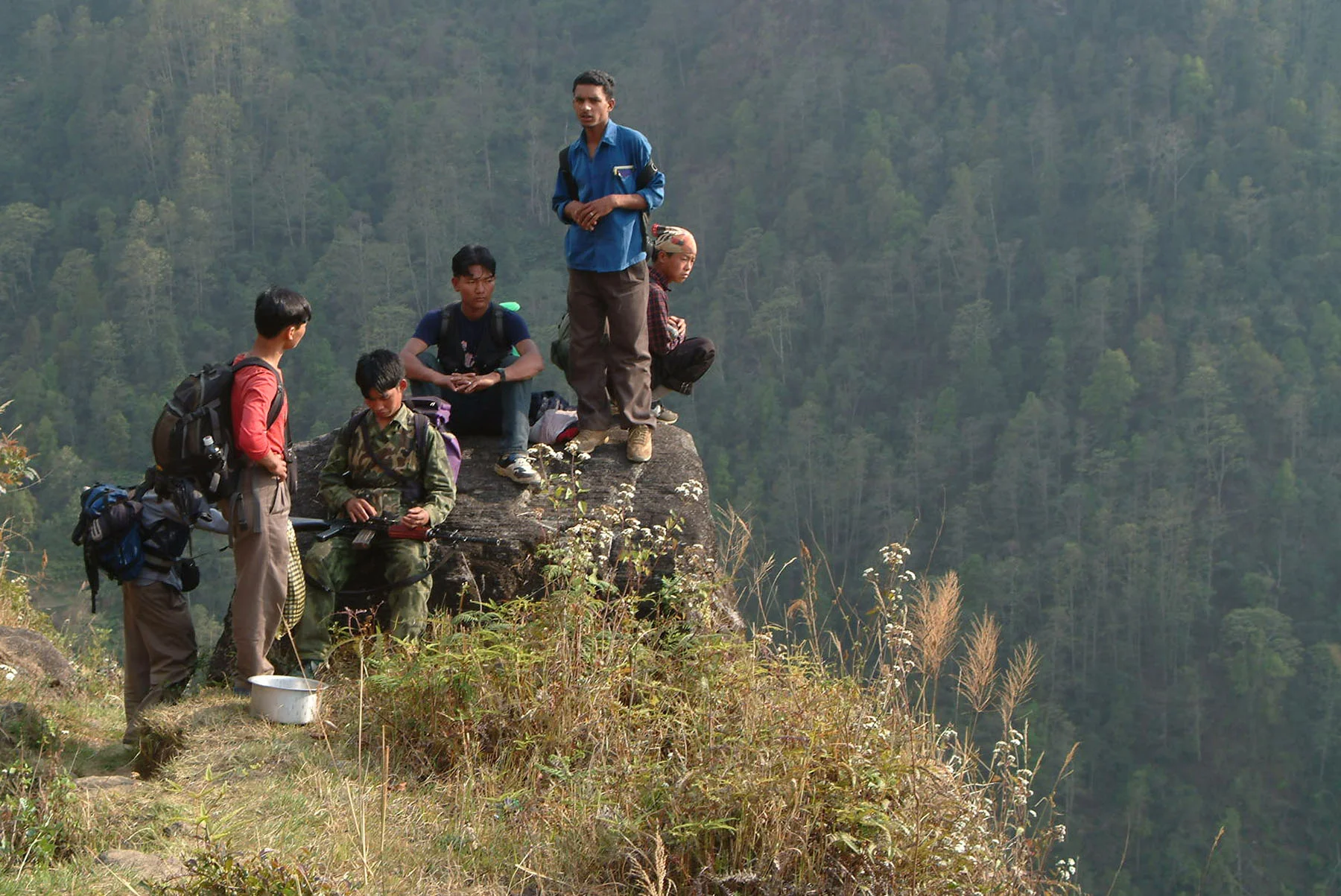 Maoist Rebel soldiers take break on a hill top while hiking to their camp, Therathum, eastern Nepal (February 2005)