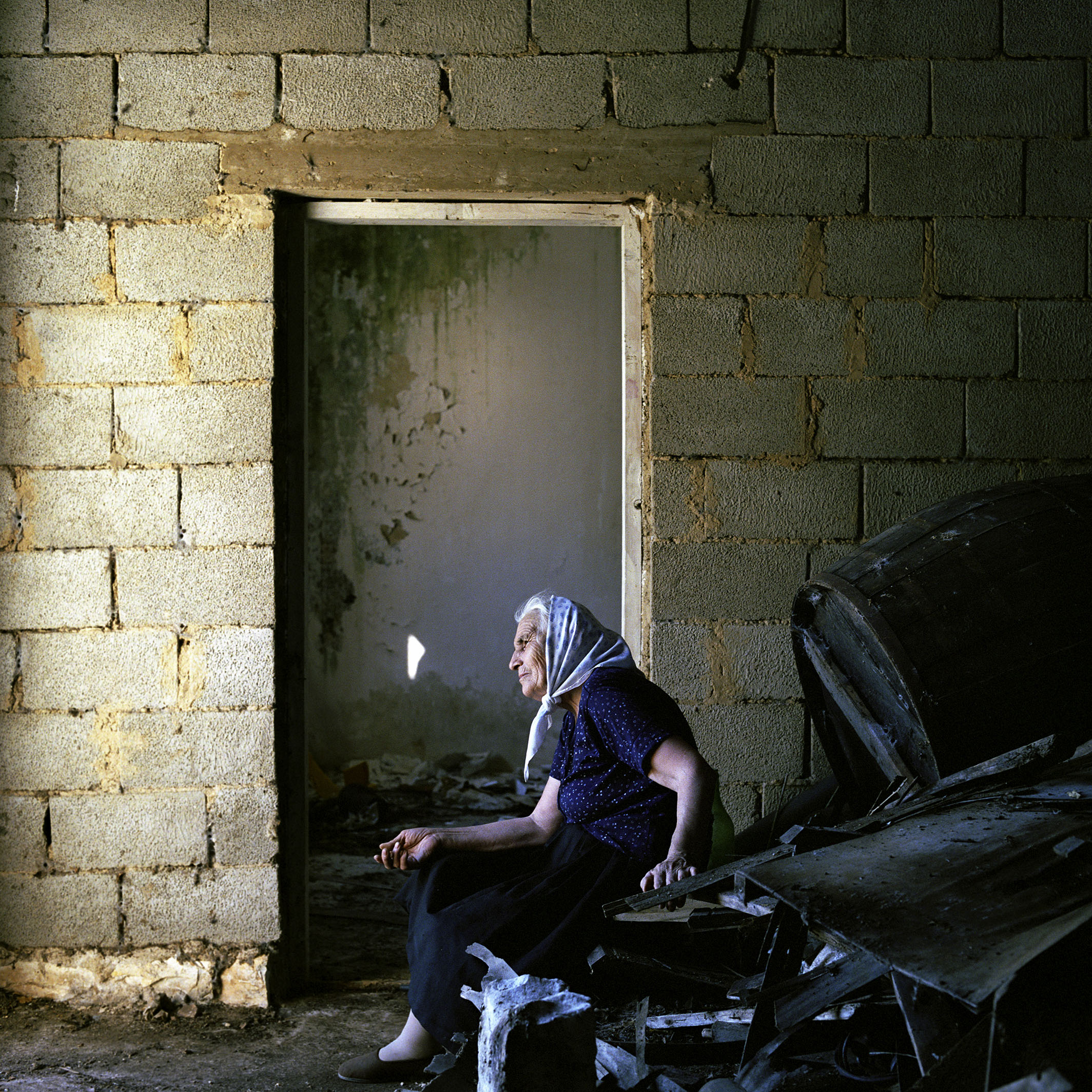  Maria Banic rests while cleaning out her dilapidated home the day after she and her husband Branko returned to Croatia from 11 years of exile in Serbia.  