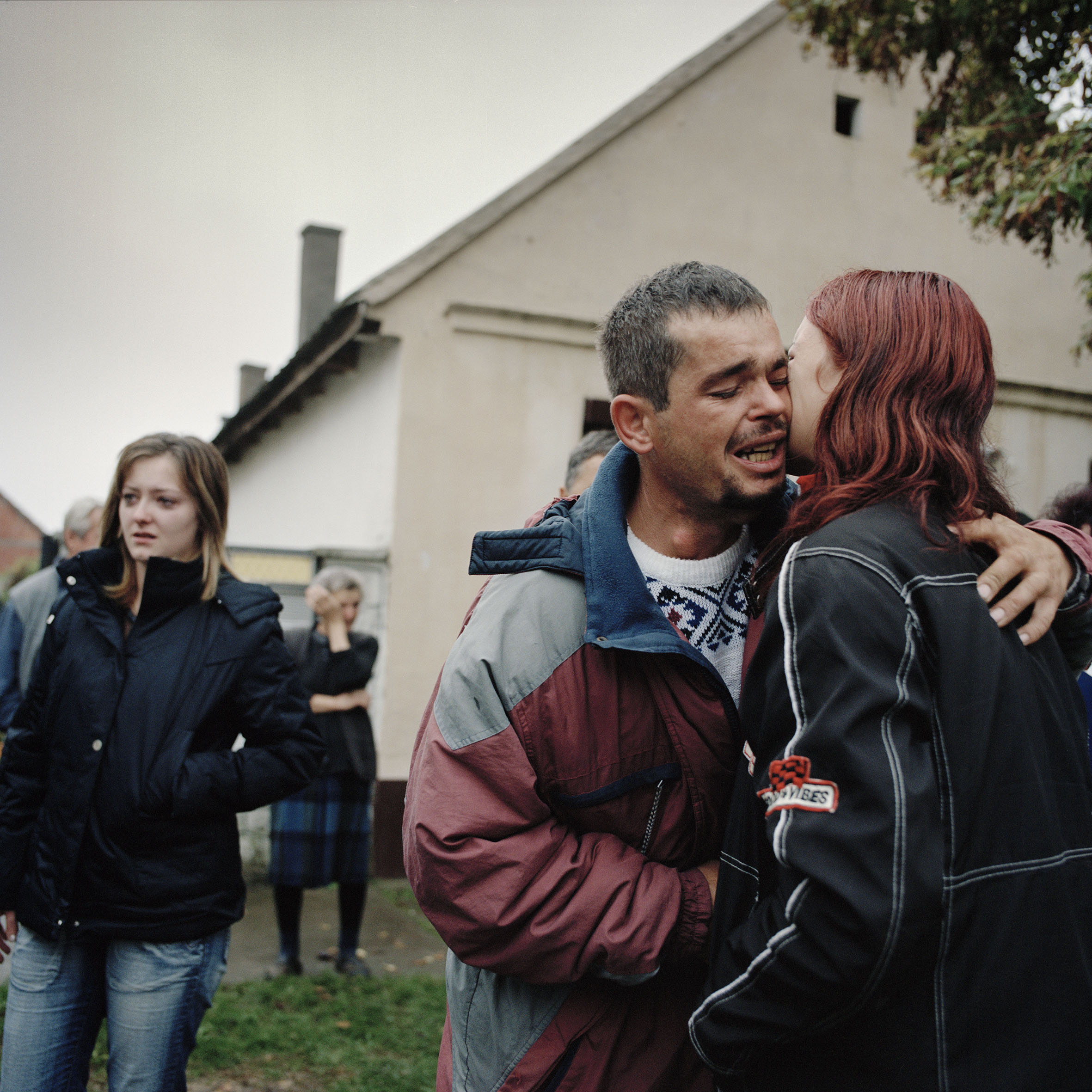  Milan Calic says goodbye to friends and family before returning to his home in Croatia with his partner and their two children. Golobinci, Serbia. 