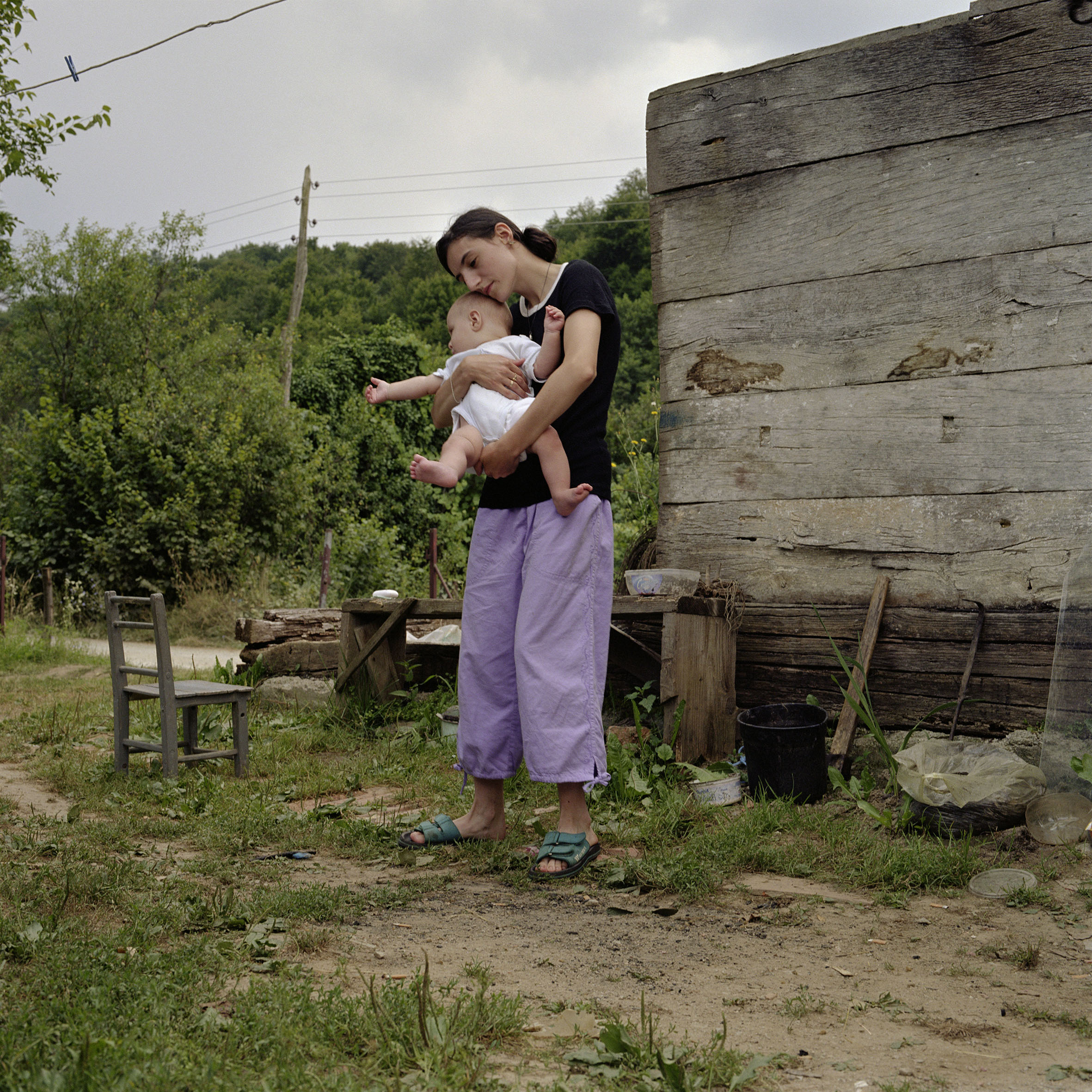  Slavica with baby Nikola outside their small cottage in Jurga, Croatia.     