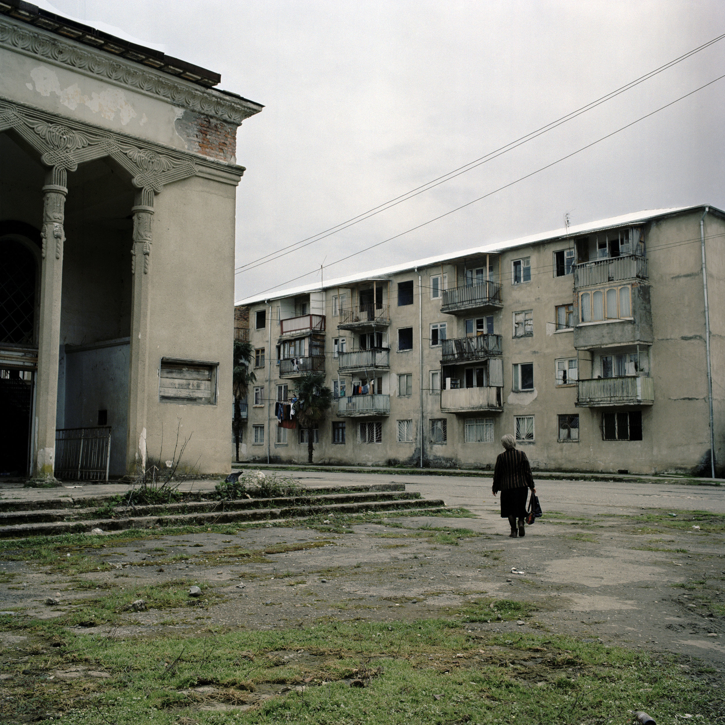 A woman walks though the dilapidated streets of Gali town.