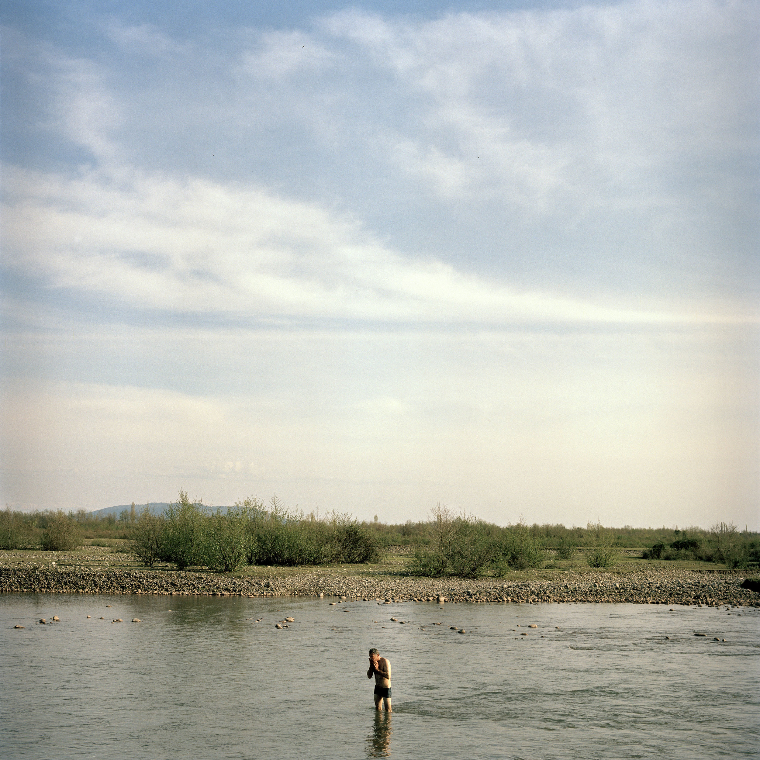 Niko Djologua takes a dip in the Ingury River which, marks the border between Georgia and Abkhazia.