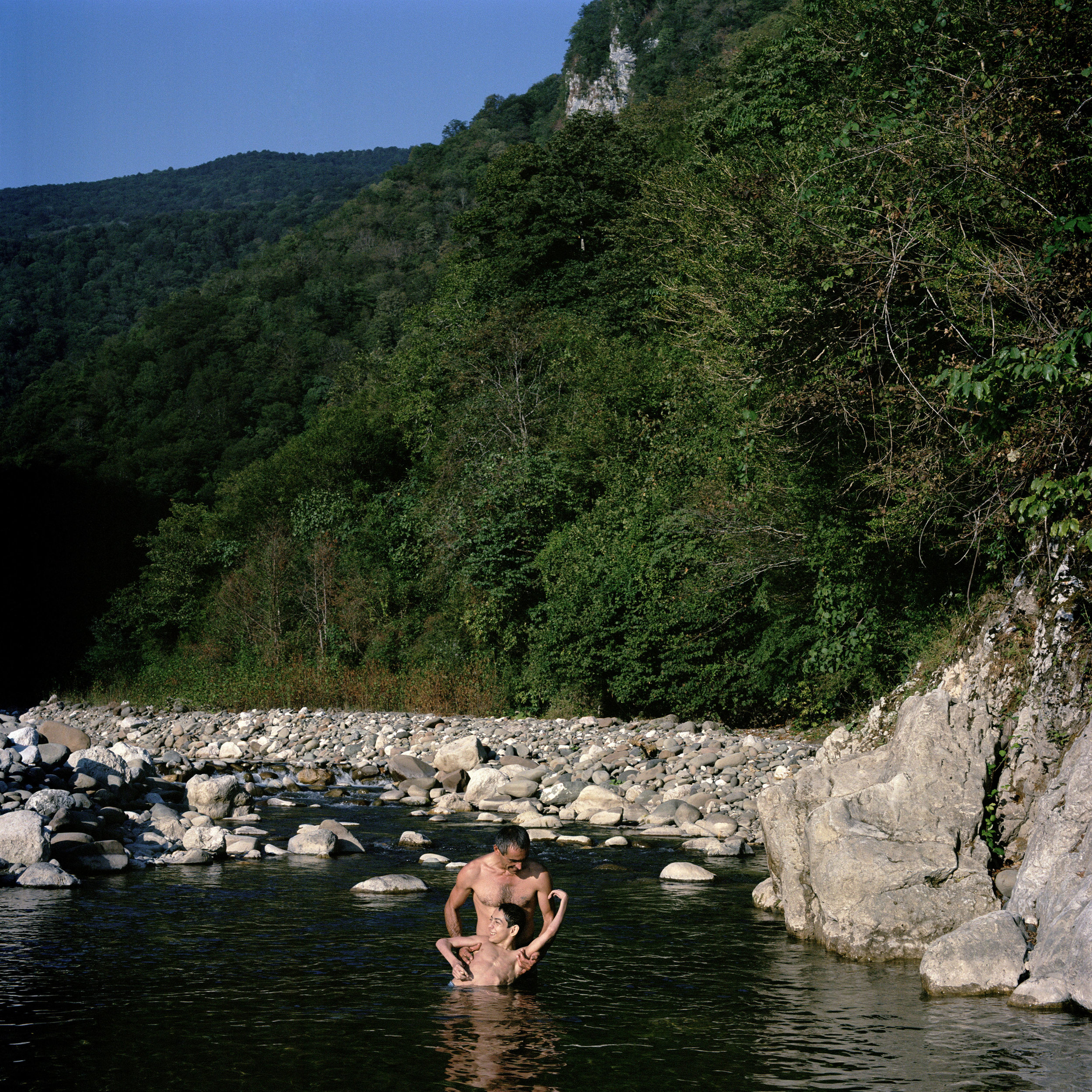 Tamas Jivanja takes his crippled 16-year-old son Romeo for a dip in a stream in the foothills of the Caucasus Mountains.